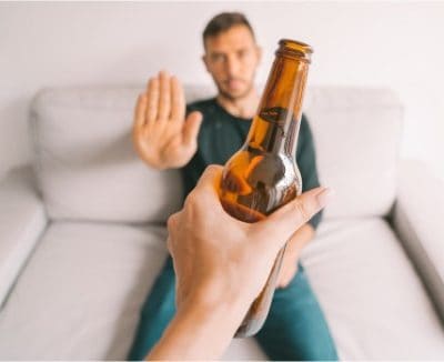 man refusing a beer