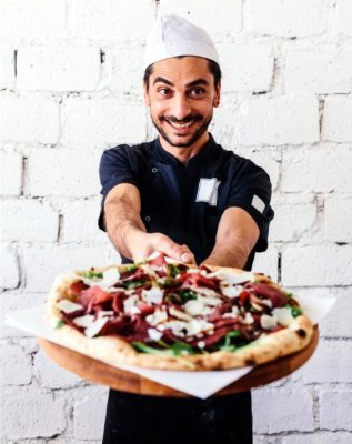 man offering pizza