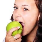 She is eating an apple